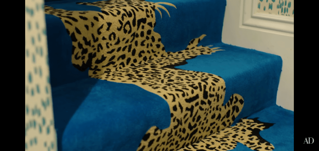 Cara Delevigne Home - Blue Carpet with Tiger print next to Victorian Skirting Board