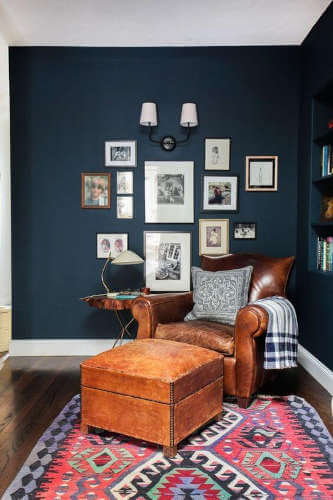 White contrasting skirting board against dark blue wall colour. White skirting boards contrasting with dark blue wall scheme.